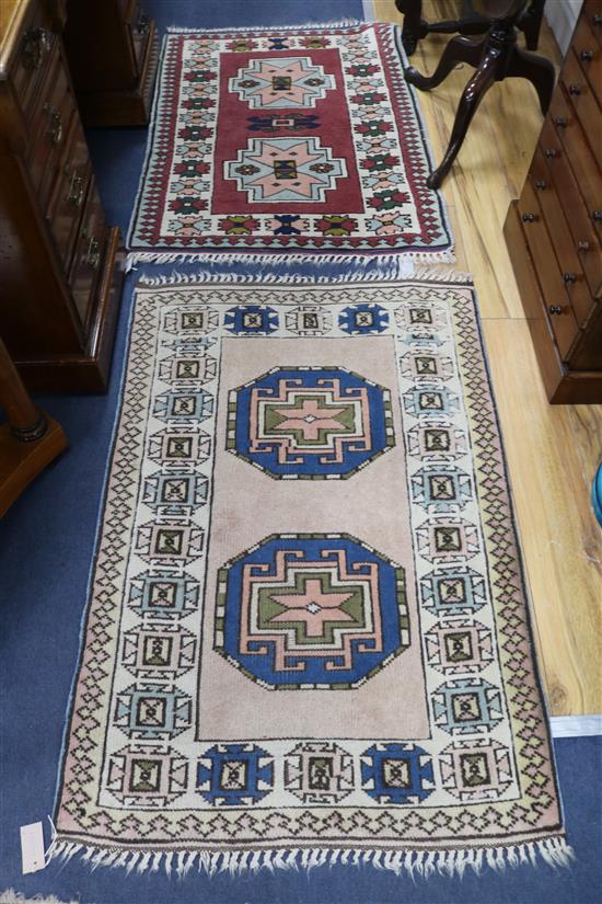 A red and cream ground rug and another 122 x 81cm, 108 x 78cm